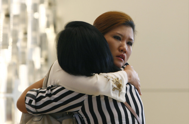 Relatives of a passenger onboard the missing Malaysia Airlines flight MH370 cry inside a hotel they are staying