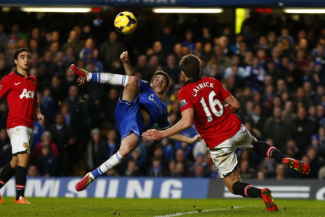 Oscar is challenged by Manchester United's Michael Carrick at Stamford Bridge.