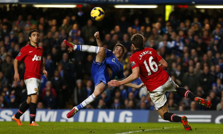 Oscar is challenged by Manchester United's Michael Carrick at Stamford Bridge.