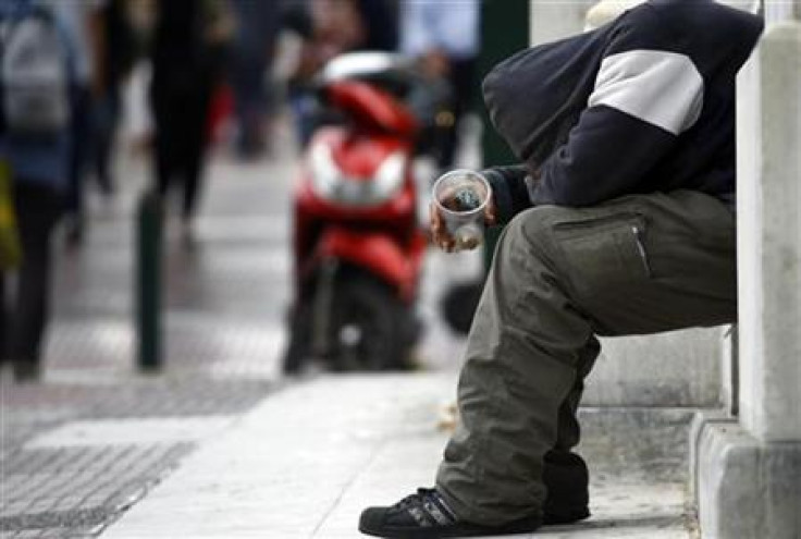 A beggar is seen on a street in central Athens