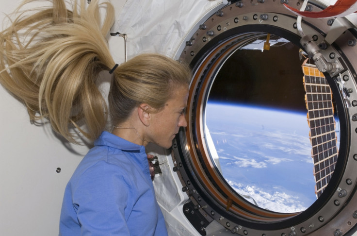 Astronaut Karen Nyberg looks through a window in the Kibo laboratory of the International Space Station