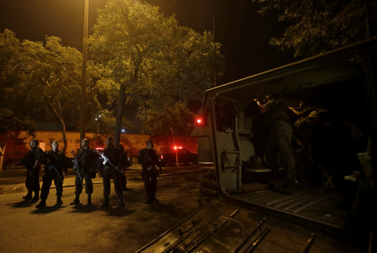 Members of the BOPE police unit patrol the favela of Parque Alegria in Rio De Janeiro.