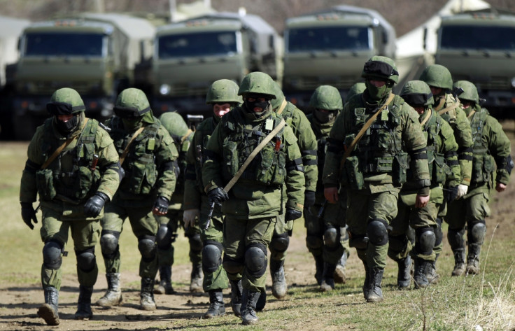 Armed men, believed to be Russians, march at their camp near the Ukrainian military base in Perevalnoye outside Simferopol