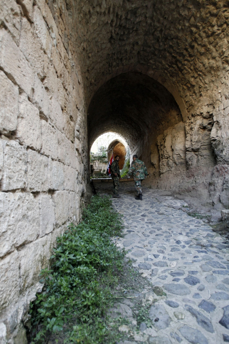 Soldiers loyal to Syria's President Bashar al-Assad walk inside the Krac des Chevaliers fortress in Homs countryside, after taking control of it from rebel fighters.