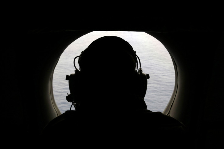 A crew member from a Royal New Zealand Airforce plane scans the Indian ocean for debris from missing Flight MH370.