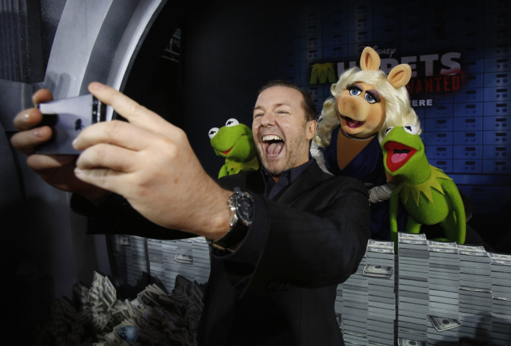 Ricky Gervais takes a "selfie" at the premiere of Muppets Most Wanted movie