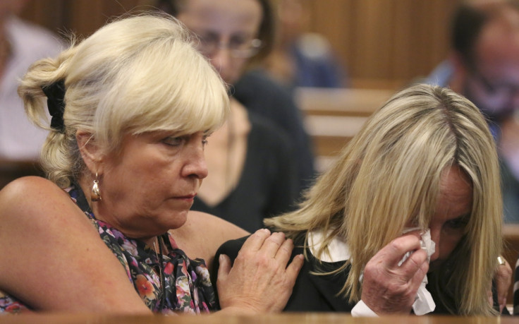 June Steenkamp (in black) is comforted by a friend while hearing about private text messages between daughter Reeva and Oscar Pistorius
