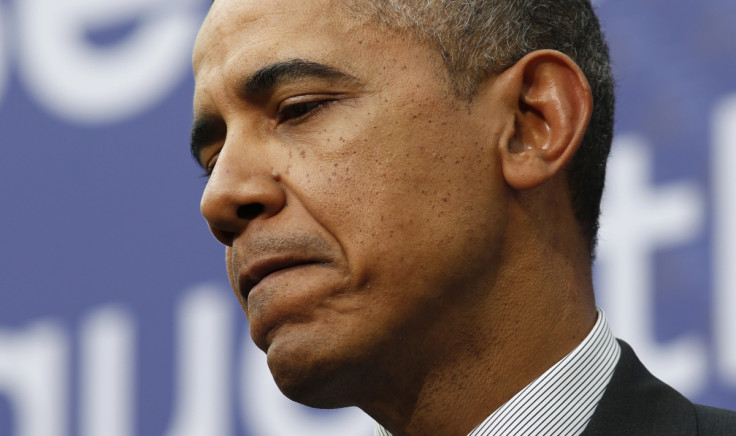 U.S. President Barack Obama looks down as he and Netherlands' Prime Minister Mark Rutte hold a joint news conference at Gemeentemuseum Den Haag at the conclusion of the Nuclear Security Summit in The Hague