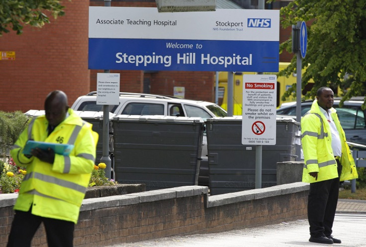 Guards patrol the entrance to Stepping Hill Hospital in Greater Manchester, where eight people died after being deliberately poisoned.