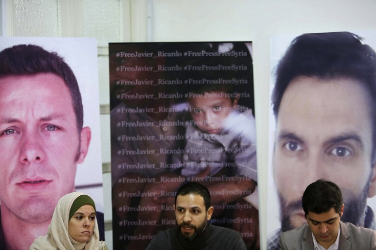 Monica Prieto (Left) wife of Spanish journalist Javier Espinosa sits at a press conference in front of images of Espinosa and photographer Ricardo Garcia Vilanova.