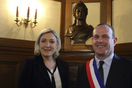 Steeve Briois (R), the new Mayor of Henin-Beaumont, wears his mayoral tricolour sash as he poses with Marine Le Pen, France's far-right National Front political party leader,