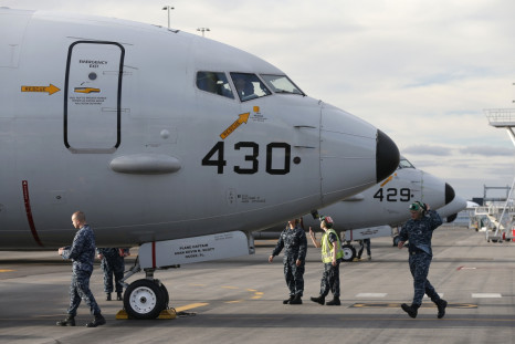 A U.S. Navy P8 Poseidon aircraft returns from a search flight for Malaysia Airlines flight MH370 over the Indian Ocean