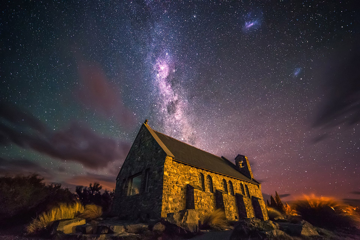 A dramatic night sky behind a little church in Tekapo, New Zealand