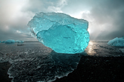 Huge iceberg sculptures on a volcanic black beach on the Jkulsrln lagoon in Iceland