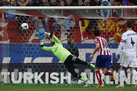Real Madrid's goalkeeper Diego Lopez (L) fails to save a shot from Ateltico Madrid's Gabi Fernandez (unseen) during their Spanish first division soccer match at Vicente Calderon stadium in Madrid March 2, 2014.