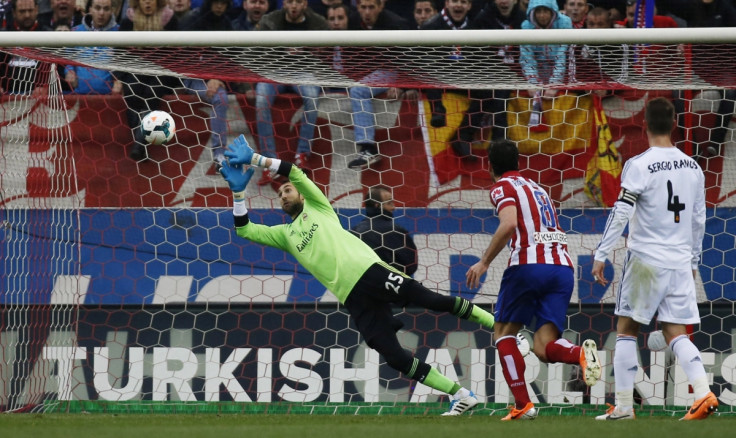 Real Madrid's goalkeeper Diego Lopez (L) fails to save a shot from Ateltico Madrid's Gabi Fernandez (unseen) during their Spanish first division soccer match at Vicente Calderon stadium in Madrid March 2, 2014.