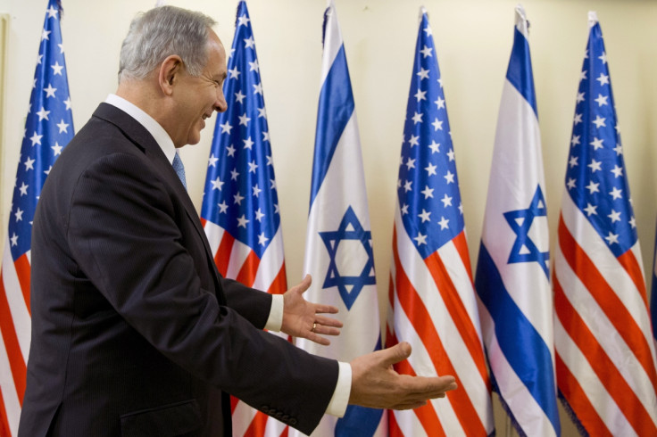 Israeli Prime Minister Benjamin Netanyahu gestures in welcome as U.S. Secretary of State John Kerry arrives for their meeting in Jerusalem