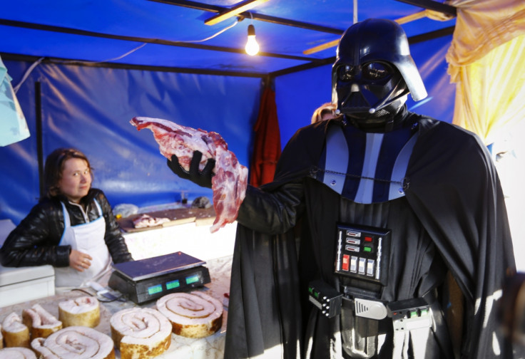 "Darth Vader", the leader of the Internet Party of Ukraine, holds a piece of meat at a street market