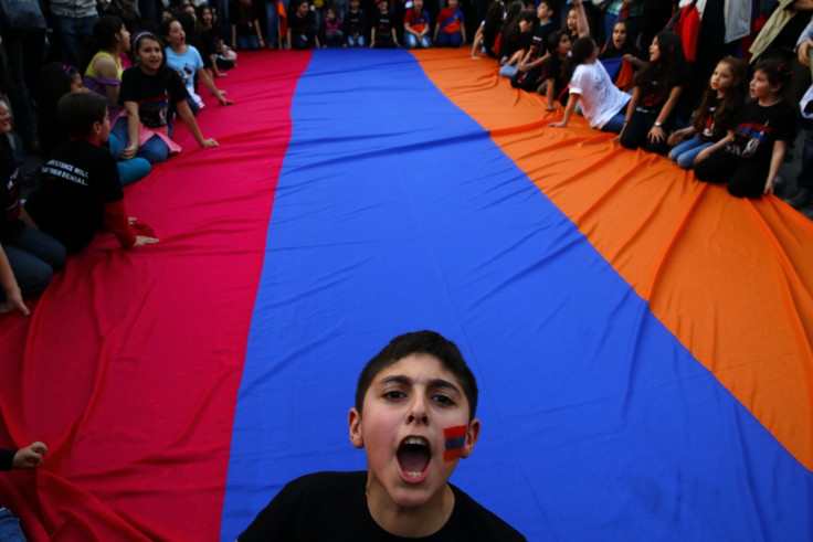 An Armenian boy shouts slogans against Turkey in front of a huge Armenian flag during a demonstration near the Turkish embassy in central Athens