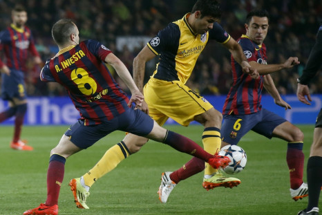 Atletico Madrid's Diego Costa (C) is challenged by Barcelona's Andres Iniesta (L) and Xavi during their Champions League quarter-final first leg soccer match at Camp Nou stadium in Barcelona April 1, 2014.
