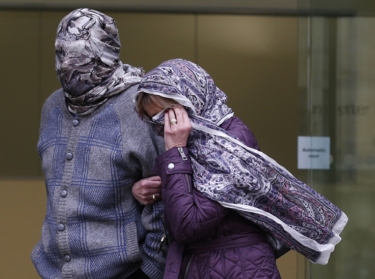 Randacore, face covered, leaves Westminster Magistrates Court with his wife in March.