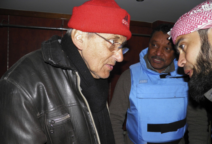 United Nations members meet with Dutch Jesuit Father Frans van der Lugt (L) and Sheikh Abu Harith al-Khalidi (R), who is in charge of negotiations for civilians inside the besieged area of Homs