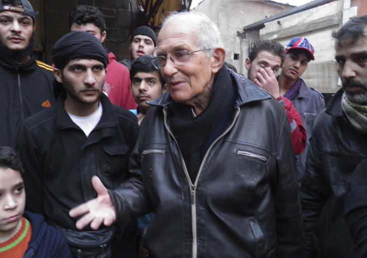 Dutch Jesuit Father Frans van der Lugt chats with civilians, urging them to be patient, in the besieged area of Homs