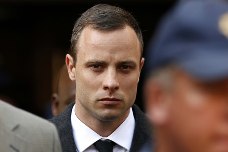 Oscar Pistorius leaves court after speaking for the first time during his trial for killing Reeva Steenkamp