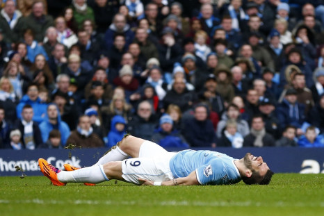 Manchester City's Alvaro Negredo lies on the ground after being awarded a penalty against Fulham during their English Premier League soccer match at the Etihad stadium in Manchester, northern England March 22, 2014.