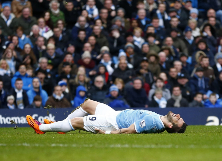 Manchester City's Alvaro Negredo lies on the ground after being awarded a penalty against Fulham during their English Premier League soccer match at the Etihad stadium in Manchester, northern England March 22, 2014.