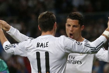 Real Madrid's Cristiano Ronaldo (R) celebrates with teammate Gareth Bale after scoring a goal against Schalke 04 during their Champions League last 16 second leg soccer match at Santiago Bernabeu stadium in Madrid March 18, 2014.