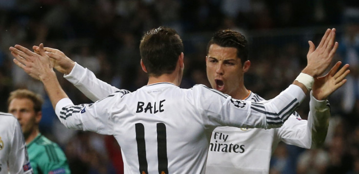 Real Madrid's Cristiano Ronaldo (R) celebrates with teammate Gareth Bale after scoring a goal against Schalke 04 during their Champions League last 16 second leg soccer match at Santiago Bernabeu stadium in Madrid March 18, 2014.
