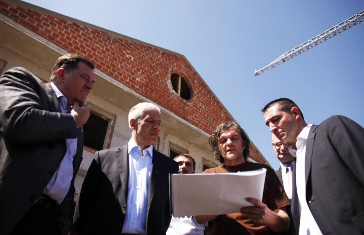 Serb Republic President Milorad Dodik (L), former Serbian President Boris Tadic (2nd L) and Serbian film director Emir Kusturica (2nd R) look at blueprints of the construction project of Andricgrad in 2012