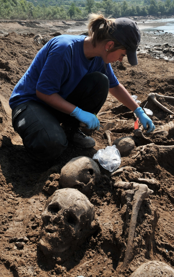 forensic expert from the International Commission On Missing Persons uncovers human remains near the eastern Bosnian town of Visegrad