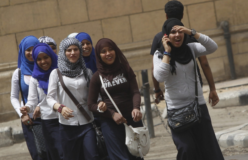School girls walk on a street in Cairo