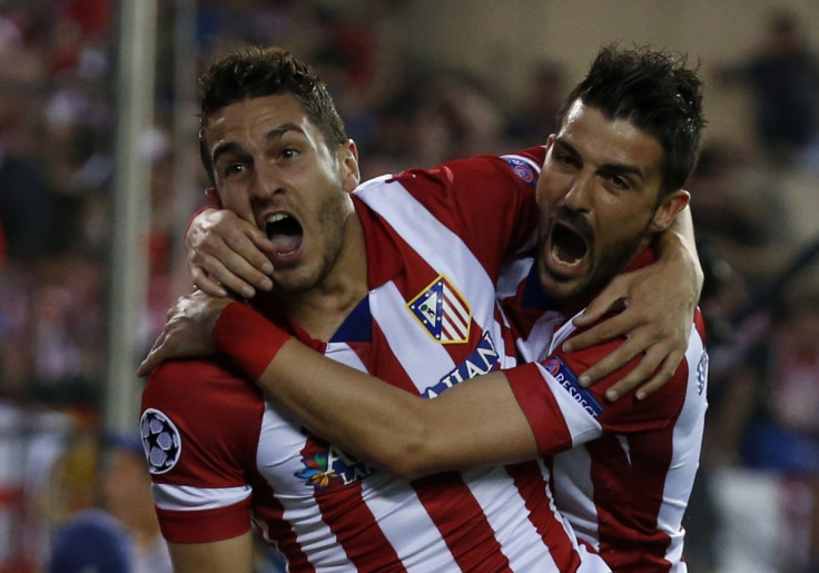 Atletico Madrid's Jorge "Koke" Resurreccion Merodio (L) and David Villa celebrate their team's first goal against Barcelona during their Champions League quarter-final second leg soccer match in Madrid, April 9, 2014.
