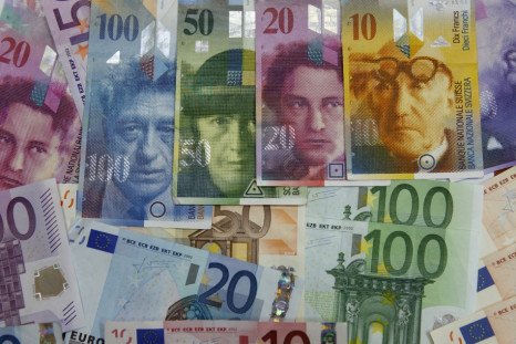 Varoius Euro banknotes lay next to various Swiss Franc notes in this picture illustration at a bank in Warsaw