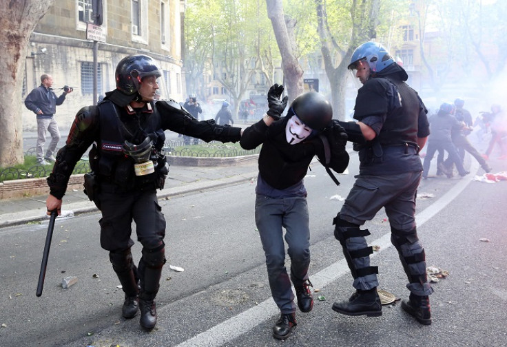 A demonstrator is detained by policemen during a protest against austerity measures in Rome.
