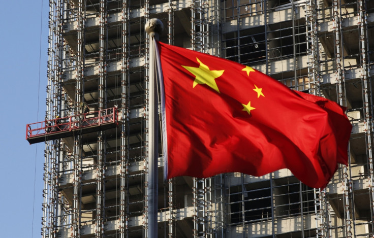 A Chinese national flag flutters at a construction site for a new residence complex in Beijing