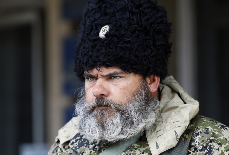 A pro-Russian armed man looks on near the mayor's office in Slaviansk