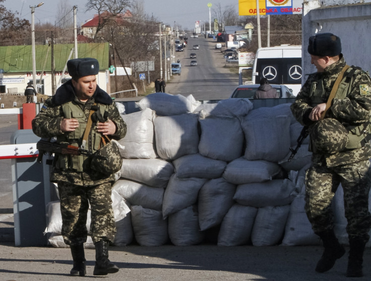Ukrainian border guards stand at a checkpoint at the border with Moldova breakaway Transnistria region, near Odessa