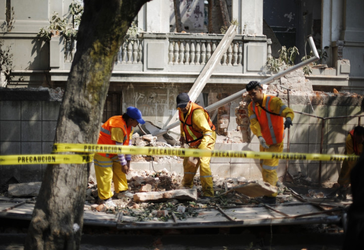 City workers remove the rubble of a wall that collapsed in an earthquake in Mexico City April 18