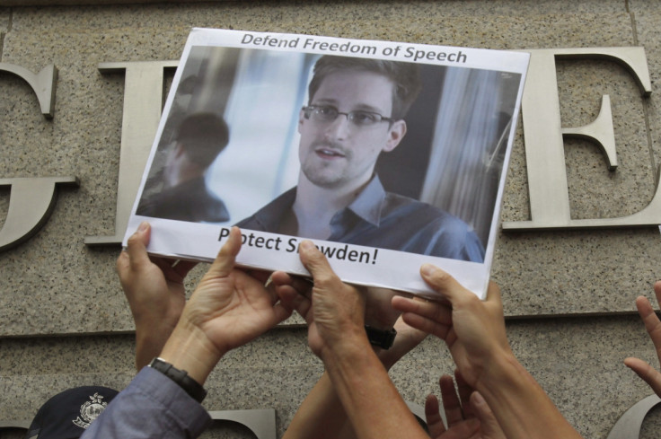 Edward Snowden sign held up by protesters