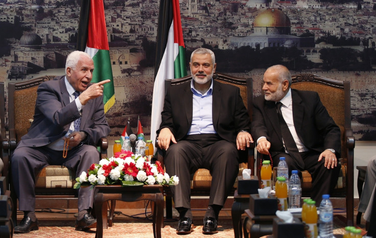 Azzam Al-Ahmed (L), a senior Fatah official and head of the Hamas government Ismail Haniyeh (C) and deputy speaker of Palestinian Parliament Ahmed Bahar attend a meeting in Gaza City