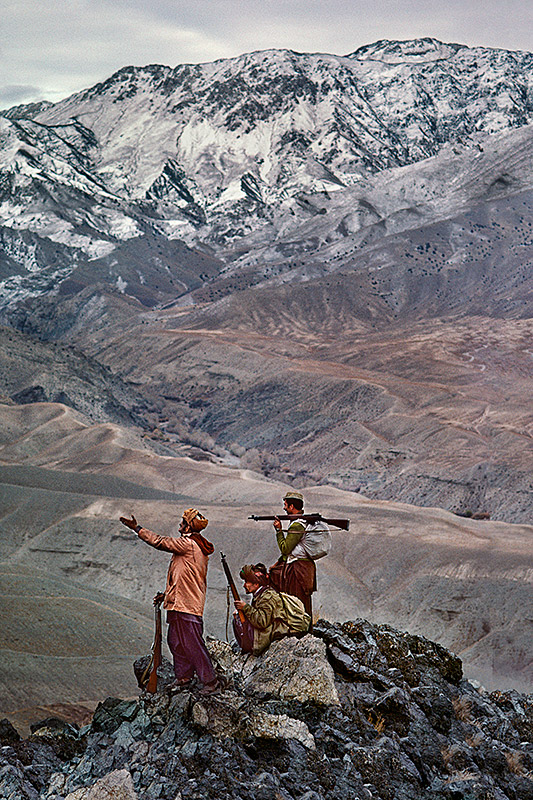 Mujahideen stand atop a mountain in the Hindu Kush, 1984