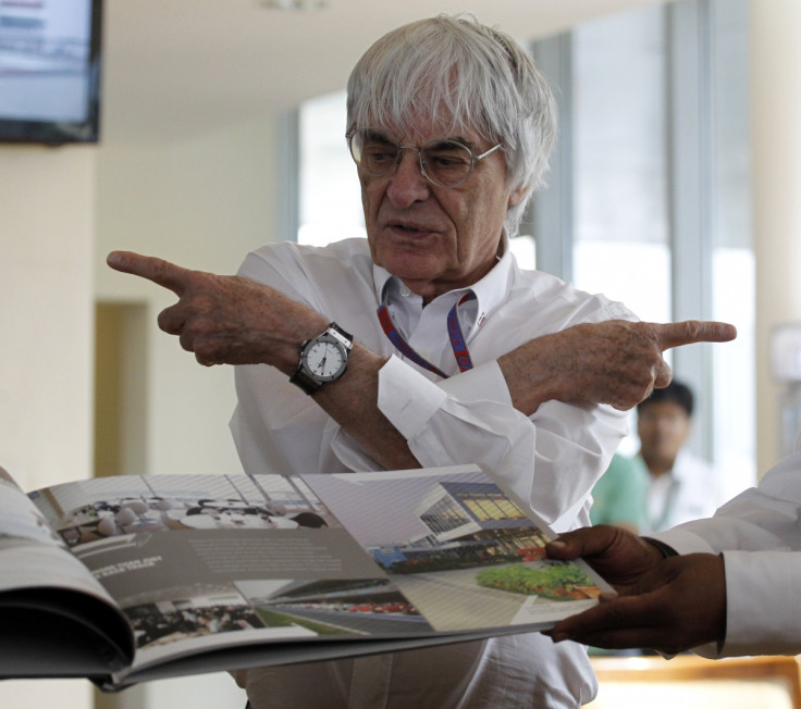 Formula One supremo Bernie Ecclestone gestures during the presentation of a commemorative book presented to him