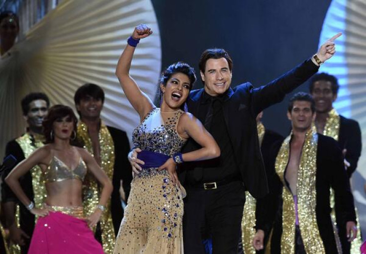 Priyanka Chopra on stage with John Travolta during IIFA 2014