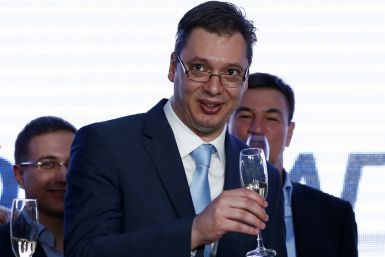Serbian Deputy Prime Minister and the leader of Serbian Progressive Party (SNS) Aleksandar Vucic toasts with champagne at the party headquarters in Belgrade March 16, 2014.