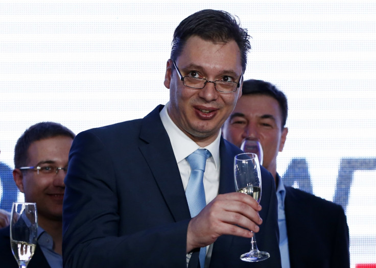 Serbian Deputy Prime Minister and the leader of Serbian Progressive Party (SNS) Aleksandar Vucic toasts with champagne at the party headquarters in Belgrade March 16, 2014.