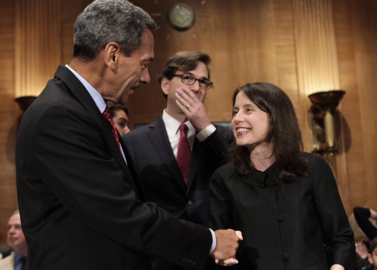 Representative Mel Watt (L), nominee to be the regulator of mortgage finance firms Fannie Mae and Freddie Mac, shakes hands with Kara Stein